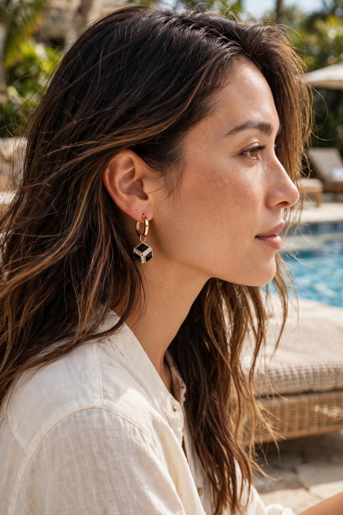 Model wearing the Black Cube Huggie Hoop Earrings