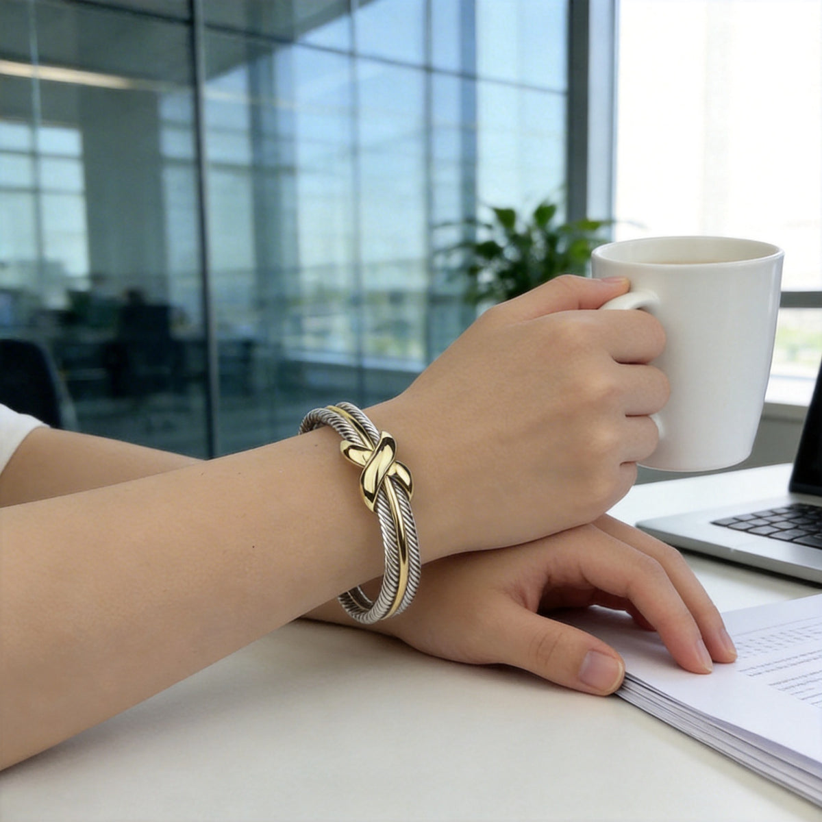 Two-tone cable X cuff worn at the desk