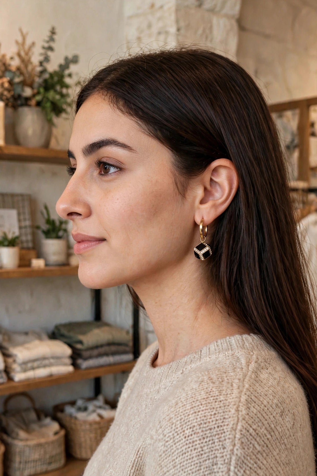Model wearing the Black Cube Huggie Hoop Earrings