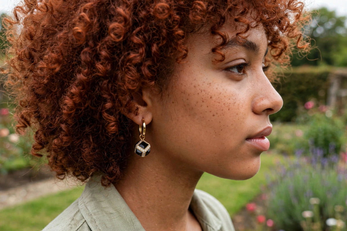 Model wearing the Black Cube Huggie Hoop Earrings