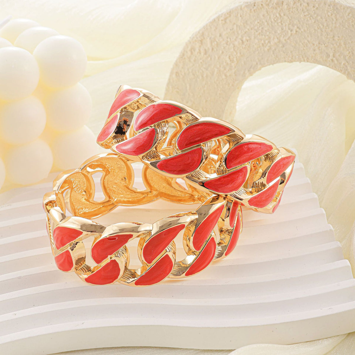 Red enamel chain-link bangles styled