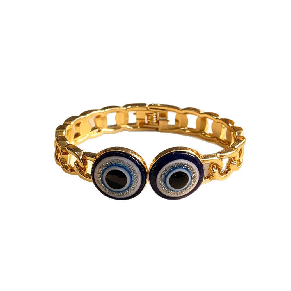 Gold evil eye openwork link bangle on white