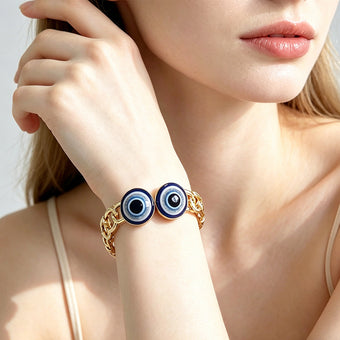 Gold evil eye openwork link bangle worn on the wrist