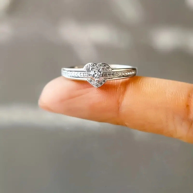 Pavé heart halo ring on a fingertip