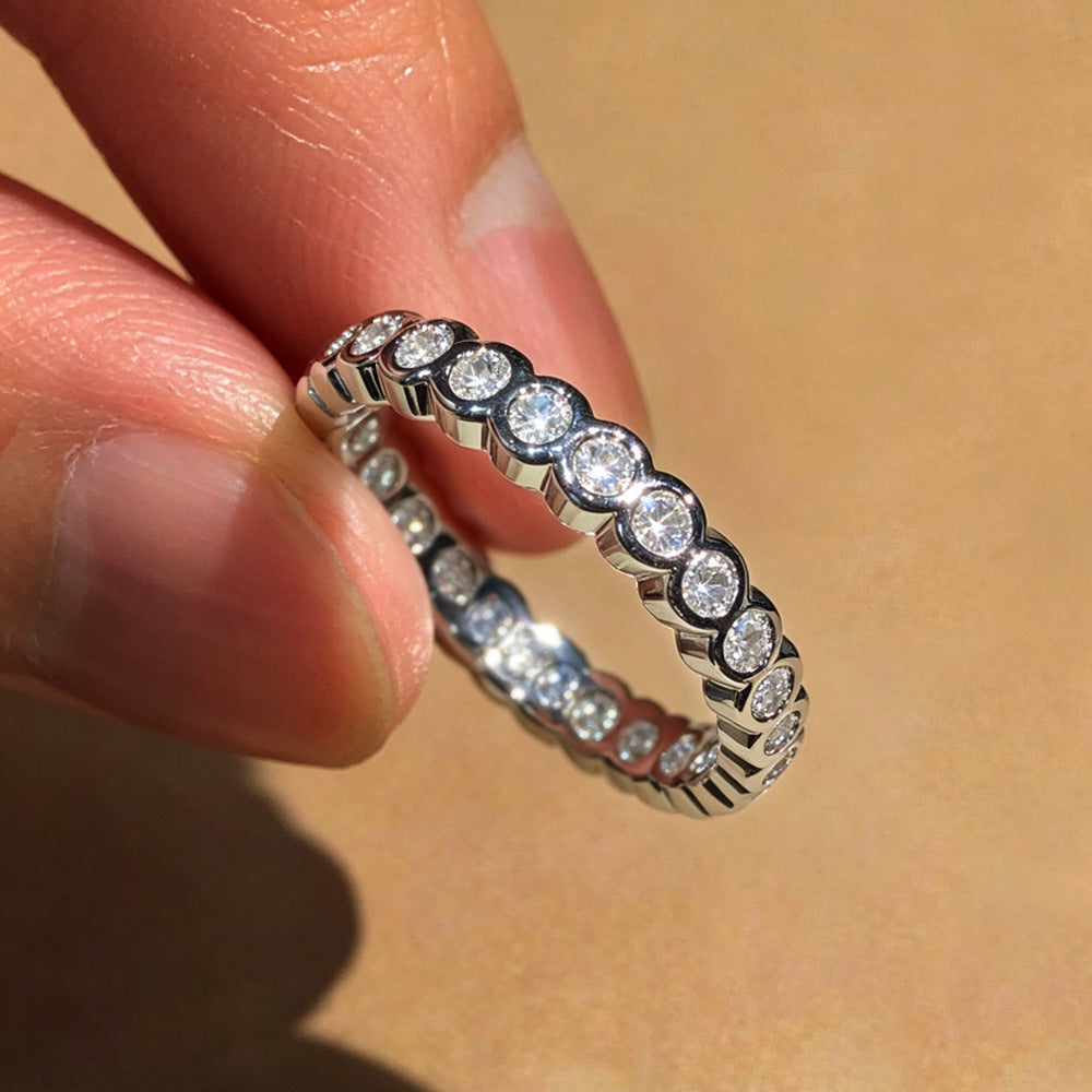 Eternity band ring held in hand