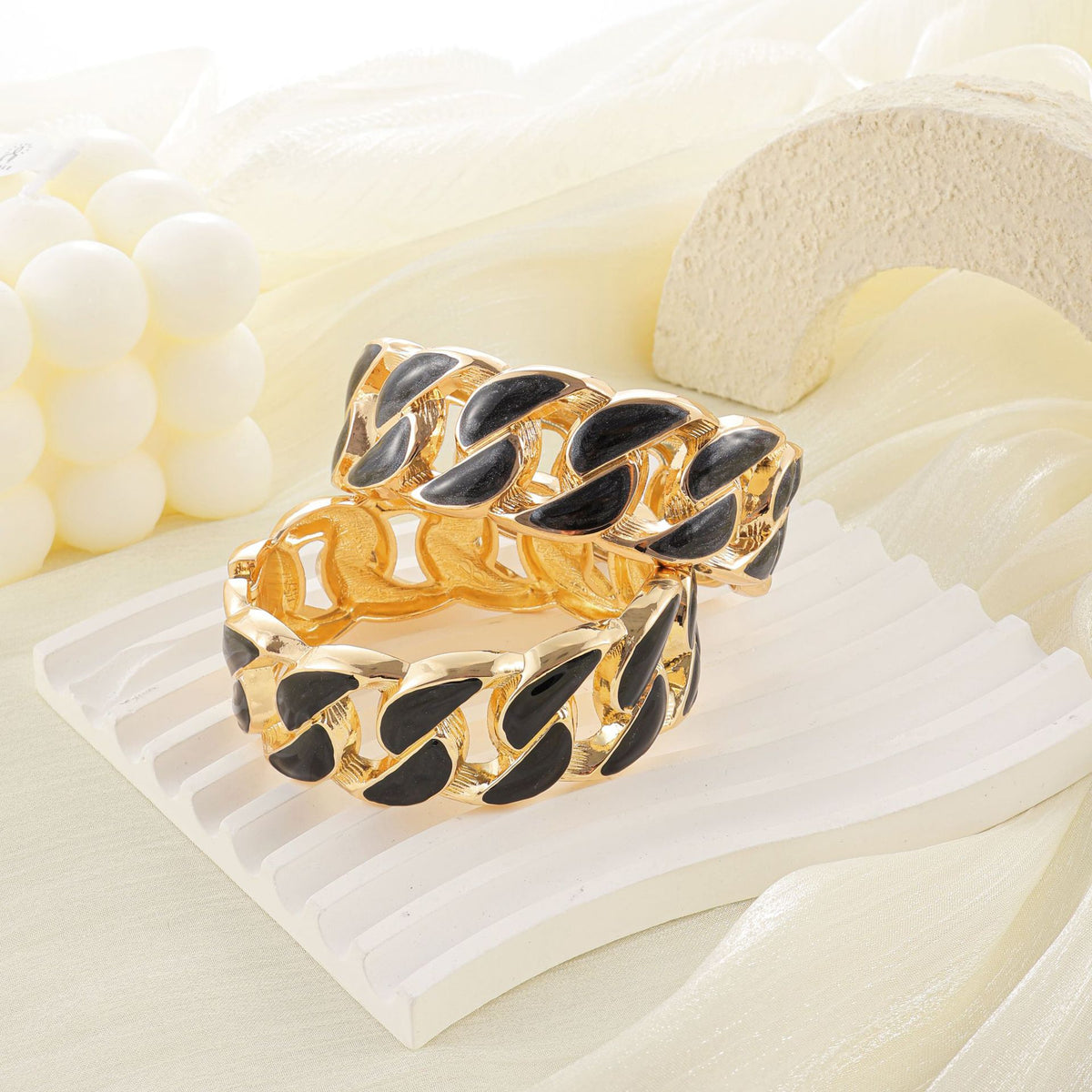 Black enamel chain-link bangles styled