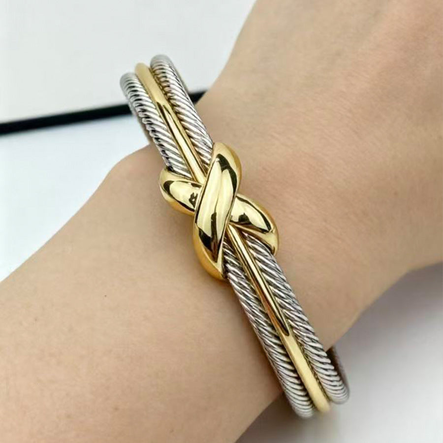 Two-tone twisted cable X crossover cuff bracelet worn