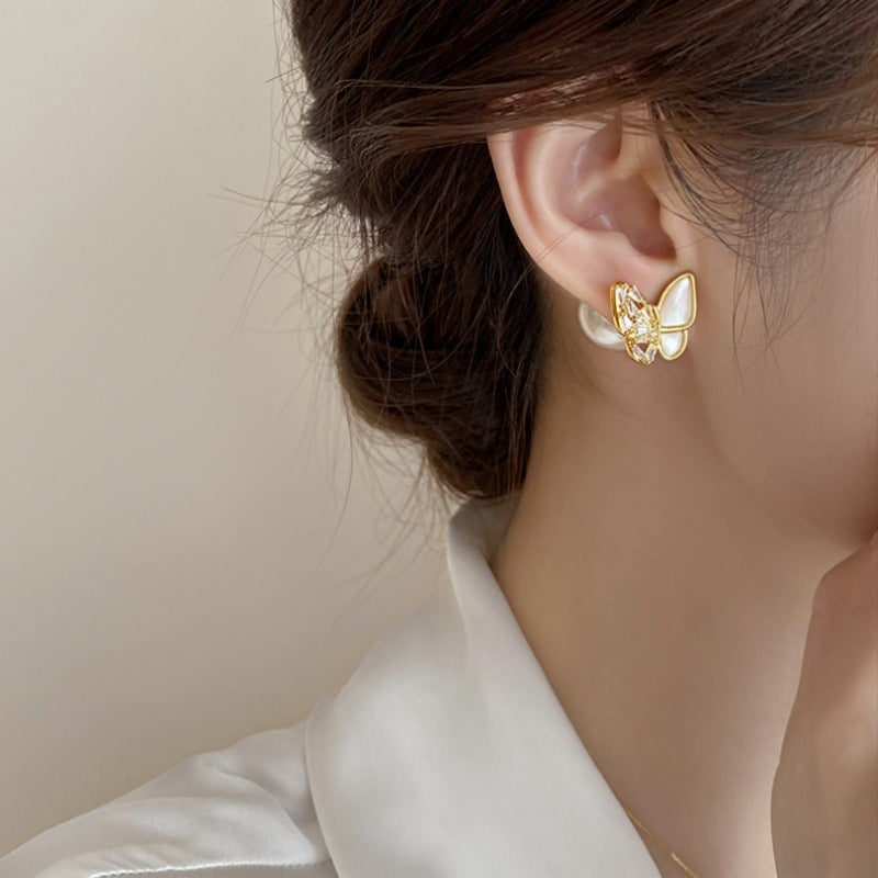 Butterfly pearl stud worn on the ear