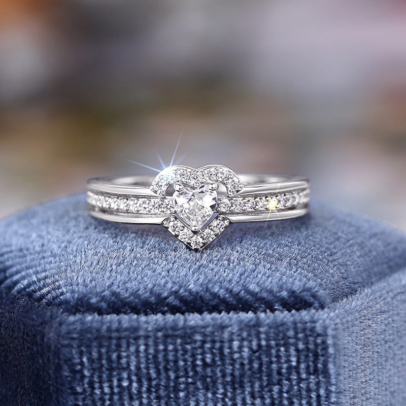 Silver pavé heart halo ring on display