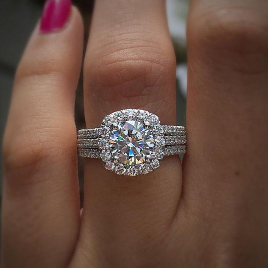 Silver cushion halo triple-row pavé ring worn