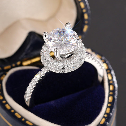 Round solitaire ring with hidden halo in a ring box